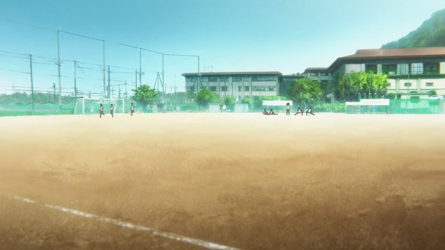 School field overlooking classroom building
